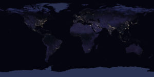 The Earth from space at night showing electrical grids across the world.